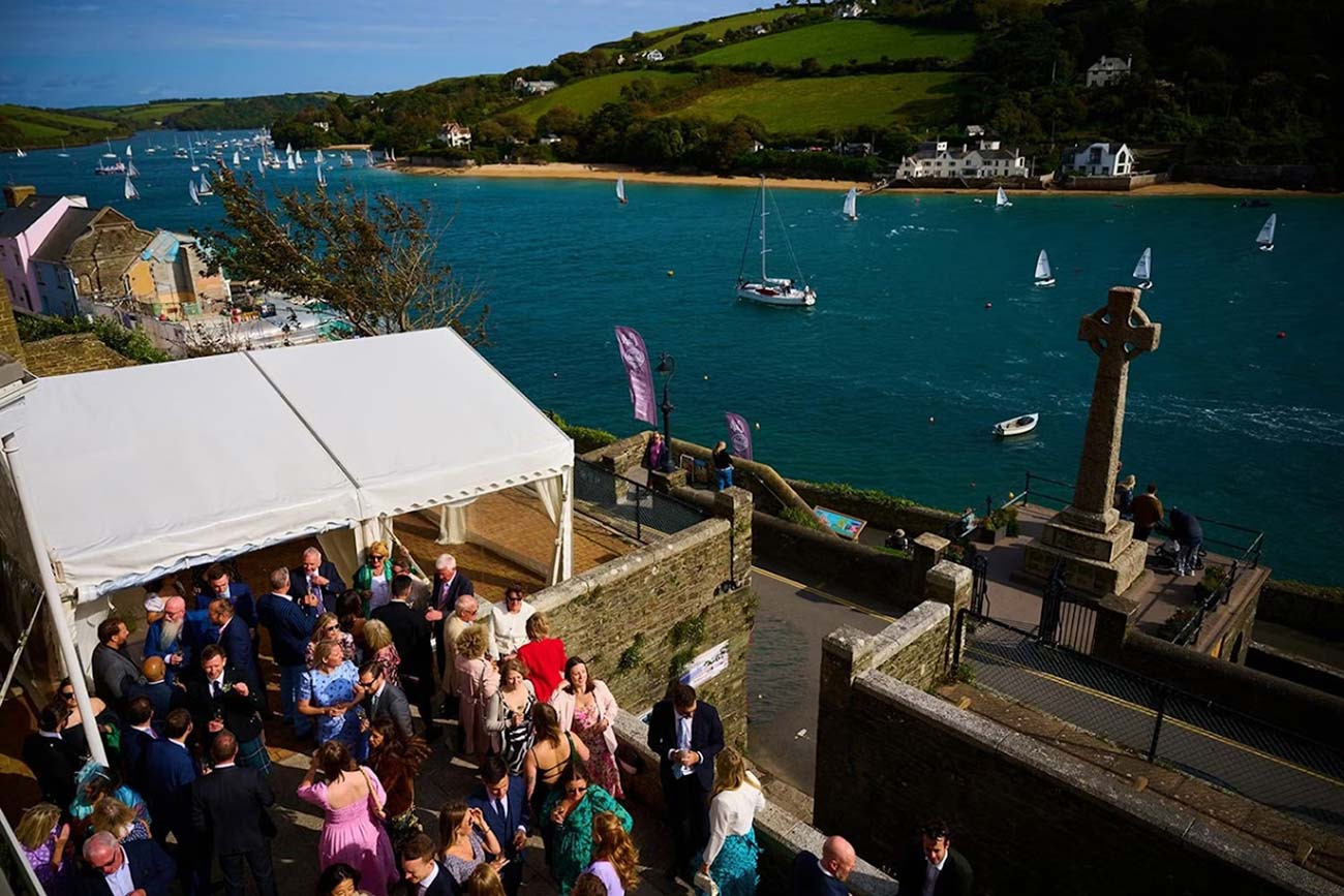 Guests gathered by a marquee on the Cliff House terrace