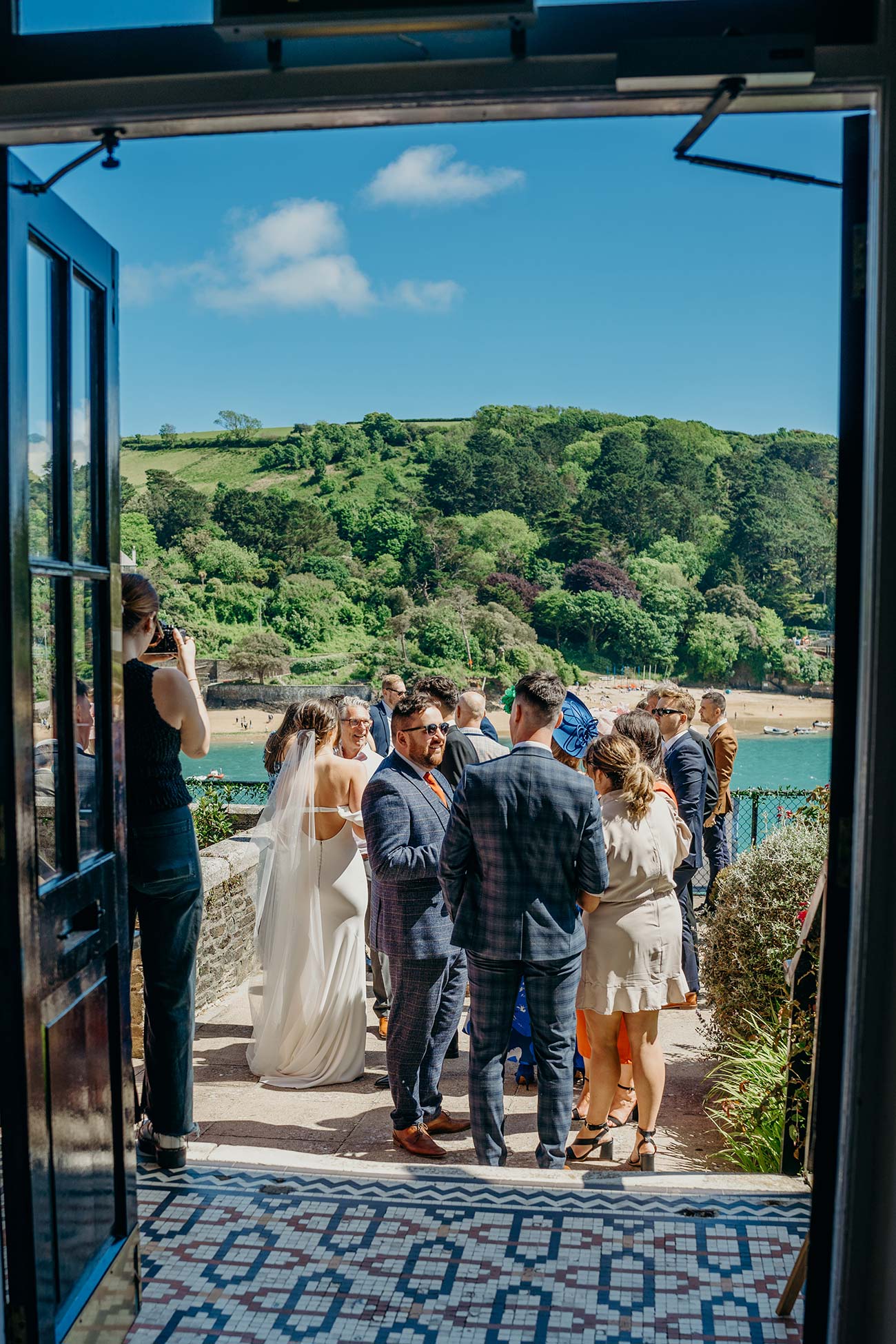 Guests arriving through open Cliff House doors