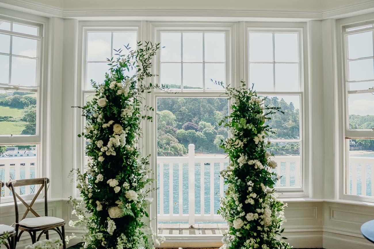 The Library arranged for a wedding ceremony with a floral arch