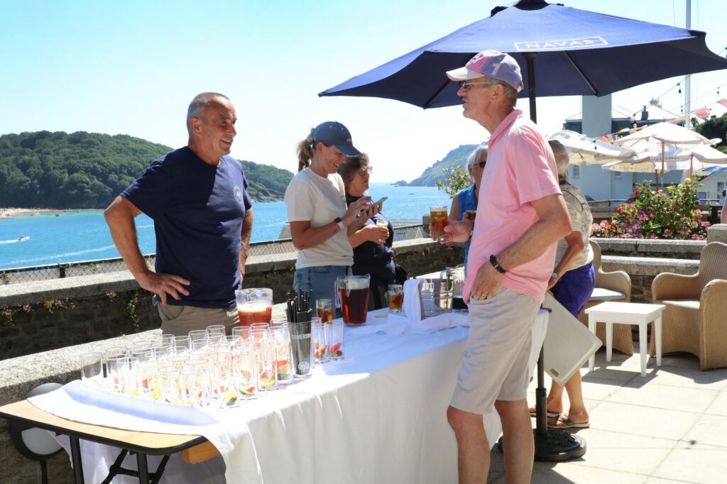 Guests enjoying drinks on the Cliff House terrace with the Salcombe Estuary beyond