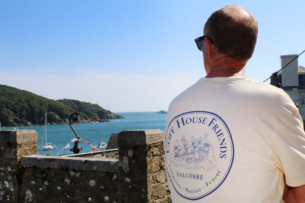 Two guests enjoying the sunshine beside the Salcombe Estuary