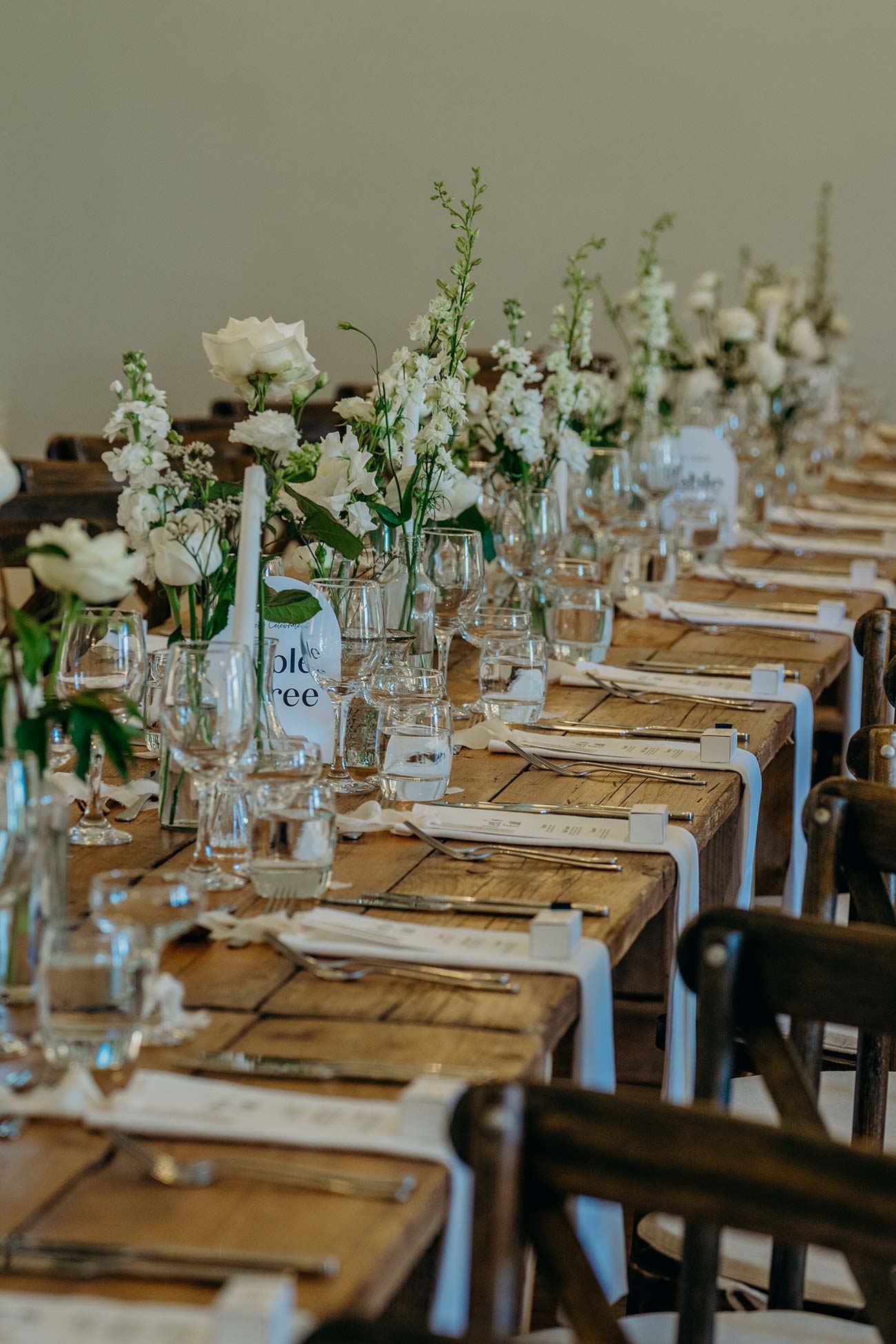 Long wedding breakfast table dressed with flowers