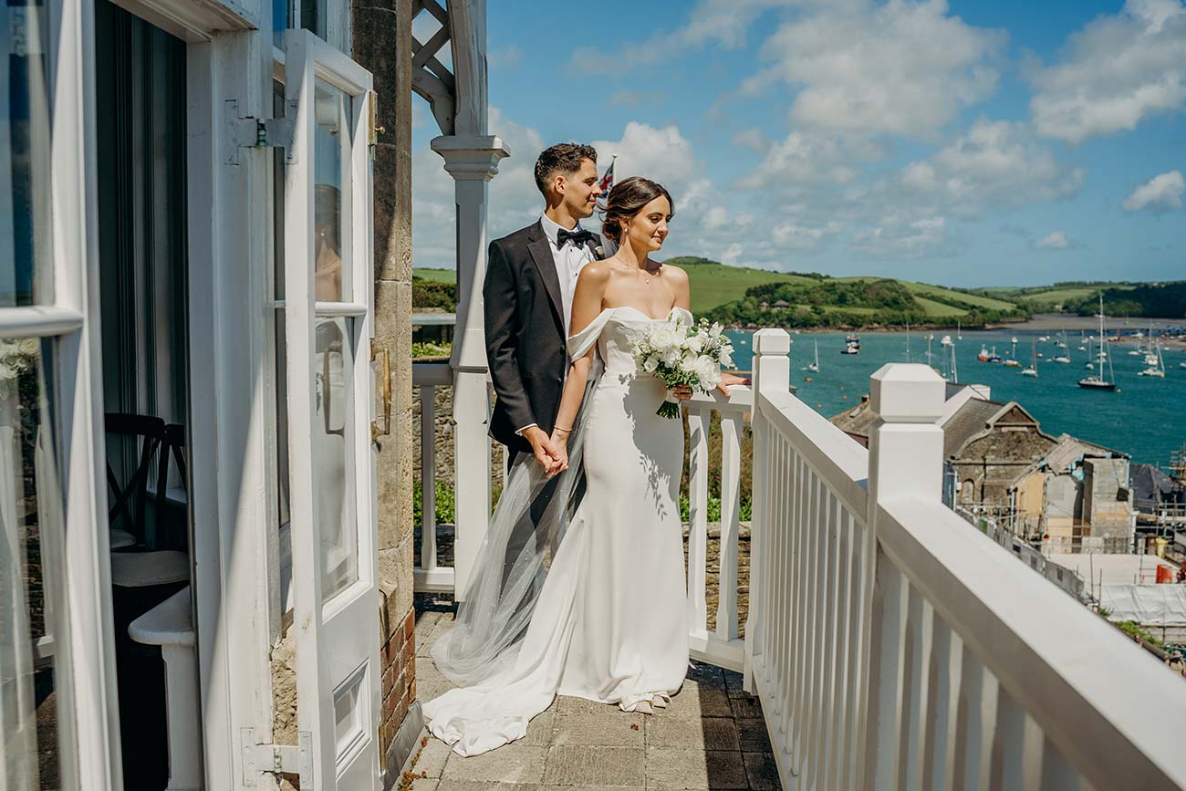 Wedding couple on the Cliff House terrace with Salcombe Estuary behind them